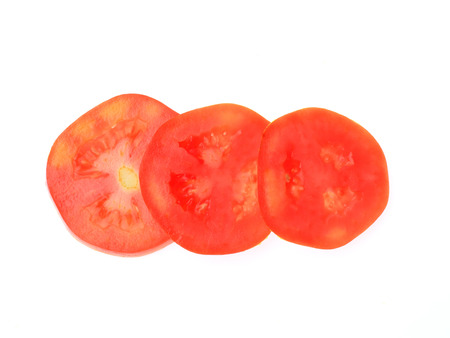 Tomato sliced isolated on white backgroundの写真素材