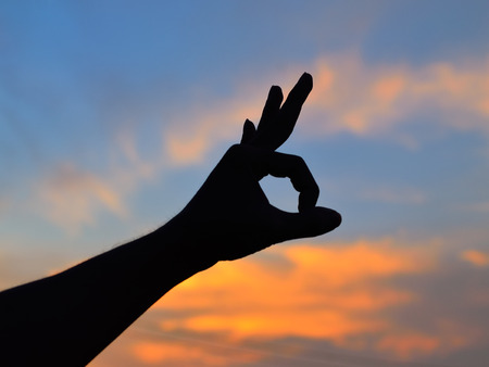 Hands up at sunsetの写真素材