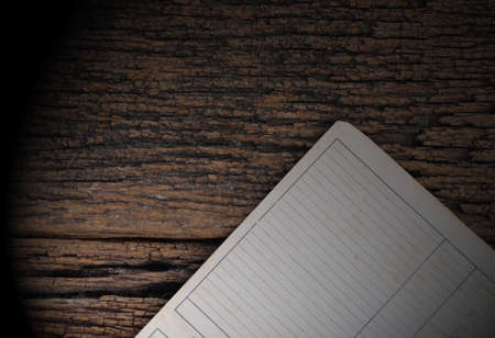 old paper sheet on aged wooden wallの写真素材