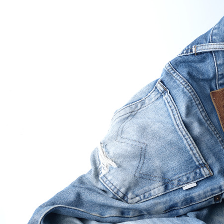 Jeans trousers stack on white backgroundの写真素材