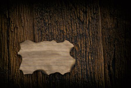 vintage grunge burnt paper at dark wooden backgroundの写真素材