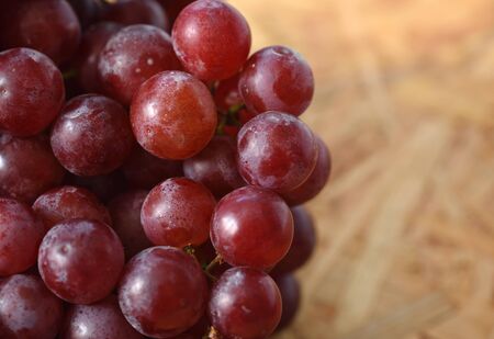 Bunch of red grapes on wooden table