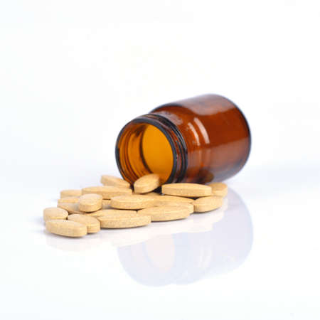 Two size of vitamin C bottle and pill with reflectionの写真素材