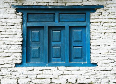 closed up the blue wood door with brick wall, in village Nepalの写真素材