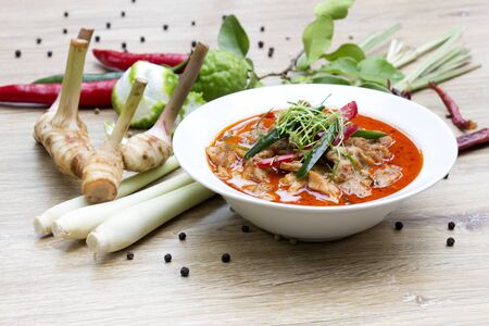 Panaeng Curry with chicken with spices, chili, lemon grass,bergamot leaf on wood/Thai Foodの写真素材