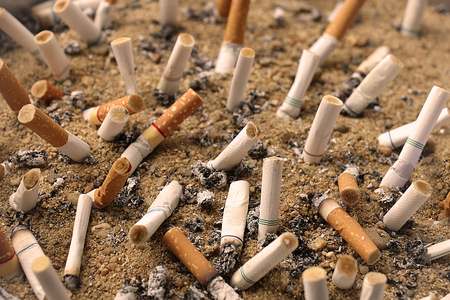 Cigarette butts in the sandbox.