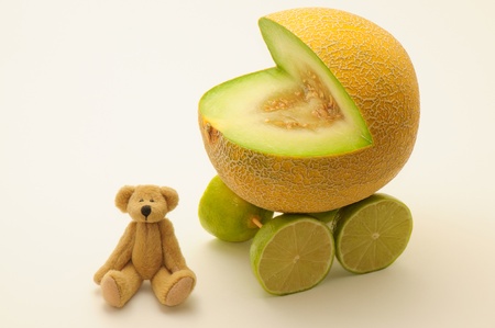 Funny card with melon buggy and teddy bear.の写真素材