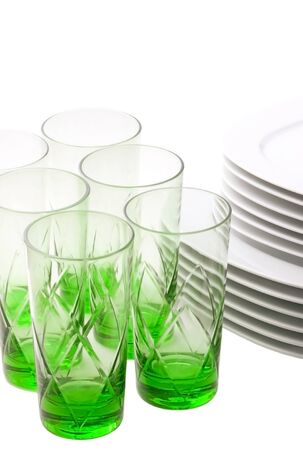 Plates and green glasses isolated on white.の写真素材
