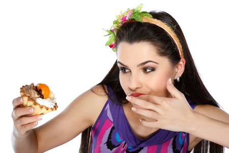 young, beautiful brunette with fruit cakeの写真素材
