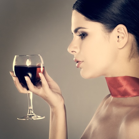 beautiful young girl  with  glass of wineの写真素材