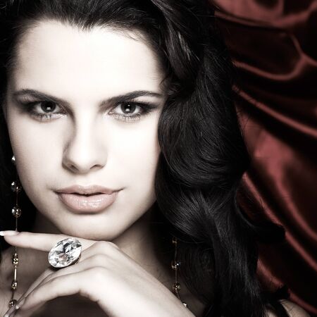 A beautiful young woman is in red clothesの写真素材