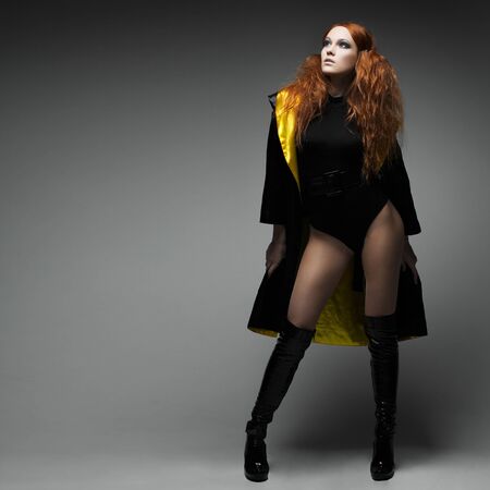 A beautiful young woman is in dark  clothesの写真素材