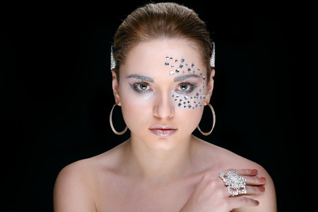 Portrait of sexual beautiful girl with strasses on face, on a black backgroundの写真素材