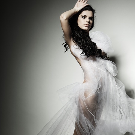 a beautiful young girl is in a bridal veilの写真素材