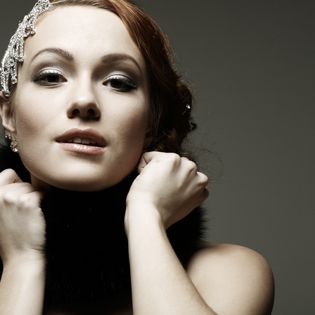 A beautiful young woman is in dark  clothes
