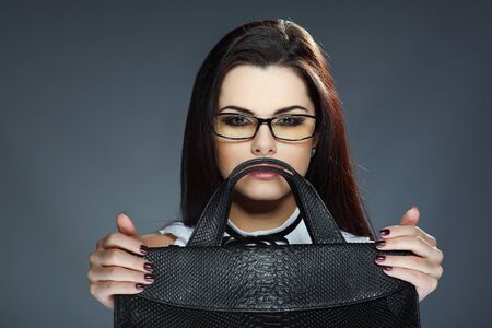 Beautiful girl in business clothes on a grey backgroundの写真素材