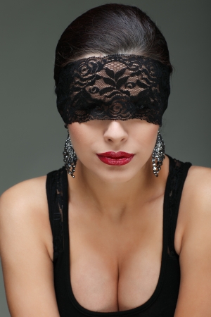 portrait elegant sexual  brunette woman is in a black lace maskの写真素材