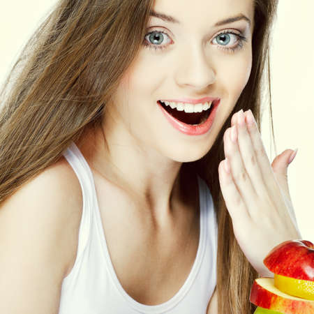 Portrait of a pretty young woman with fruit  isolated on  a white backgroundの写真素材