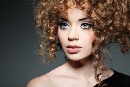 Young beautiful woman with long curly hairsの写真素材