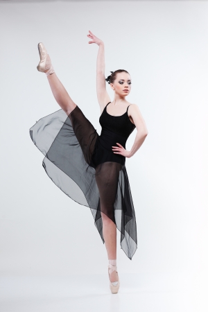 Beautiful ballet-dancer, modern style dancer posing on studio backgroundの写真素材