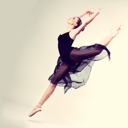 Beautiful ballet-dancer, modern style dancer posing on studio backgroundの写真素材