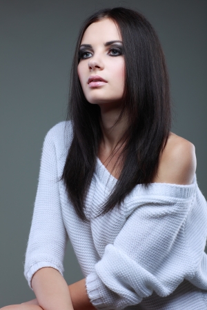 Closeup portrait of sexy  young woman with beautiful blue eyes on grey backgroundの写真素材