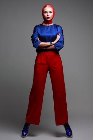 A photo of beautiful girl is in fashion style on  grey background, glamourの写真素材