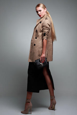 A photo of beautiful girl is in fashion style on  grey background, glamourの写真素材