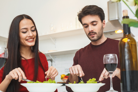 Young couple having romantic evening at home in the kitchen healthy dinnerの写真素材