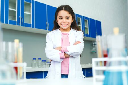 Little child with learning class in school laboratory standing confidentの写真素材