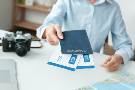 Young female travel agent consultant in tour agency documents close-upの写真素材
