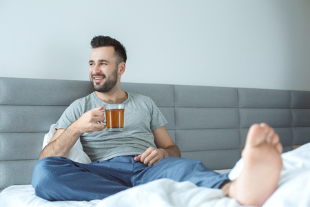 Bachelor man daily routine single lifestyle morning concept drinking teaの写真素材