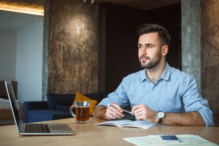 Bachelor man daily routine working from home single lifestyle concept dreamingの写真素材