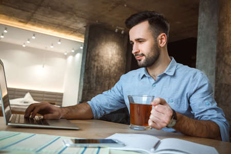 Bachelor man daily routine working from home single lifestyle concept using laptopの写真素材