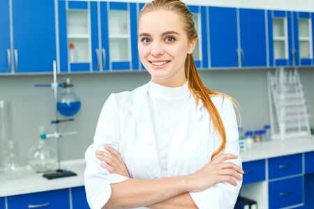 Young chemistry teacher in school laboratory work standing confidentの写真素材