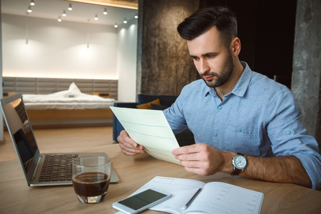 Bachelor man daily routine working from home single lifestyle concept documentsの写真素材