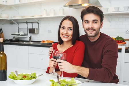 Young couple having romantic evening at home in the kitchen toastの写真素材