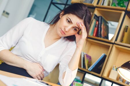 Pregnant business woman working at office motherhood sitting tiredの写真素材