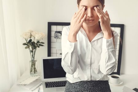Young woman freelancer indoors home office concept formal style feeling unwellの写真素材