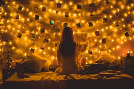 Young woman weekend at home decorated bedroom memoriesの写真素材