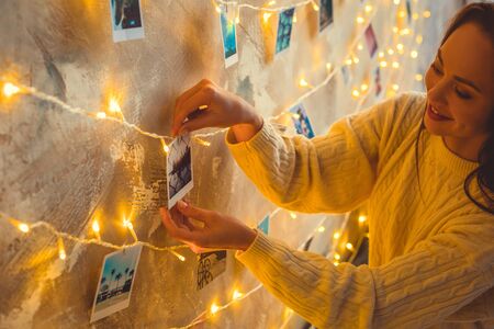 Young woman weekend at home decorated bedroom taking photoの写真素材