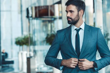 Businessman in a fromal suit in a business center button upの写真素材