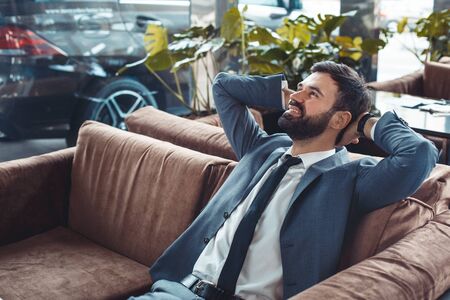 Businessman sitting in a business center restaurant rest on the sofaの写真素材
