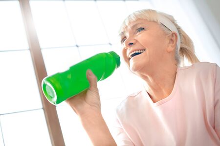 Senior woman exercise at home health care drinking water processの写真素材