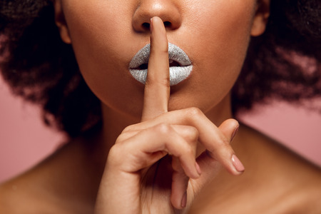 Young african woman isolated on pink wall studio fashion stylish makeup quiet close-upの写真素材