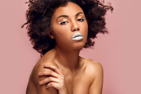 Young african woman isolated on pink wall studio fashion stylish makeup shirtlessの写真素材