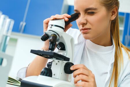Young chemistry teacher in school laboratory workplace magnificationの写真素材