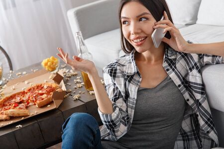 Young woman sport fan watching match holding smartphoneの写真素材