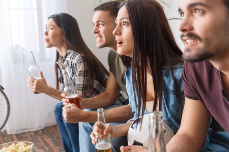 Group of friends sport fans watching soccer match interesting gameの写真素材