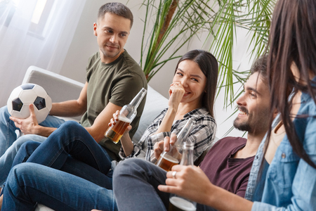 Group of friends sport fans watching football match discussionの写真素材